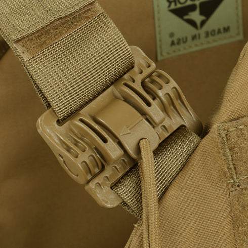 Close-up of a tan plastic buckle attached to nylon straps on the Condor Cyclone RS Plate Carrier in MultiCam Black, tactical gear favored by military and law enforcement.