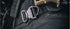 Close-up of the Condor Cobra Pro Belt, featuring a metal quick-release buckle, worn over dark pants and equipped with tactical gear in a rugged outdoor setting.