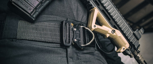 Close-up of a person wearing the Condor Cobra Pro Belt with a holstered firearm and an extra magazine pouch attached.