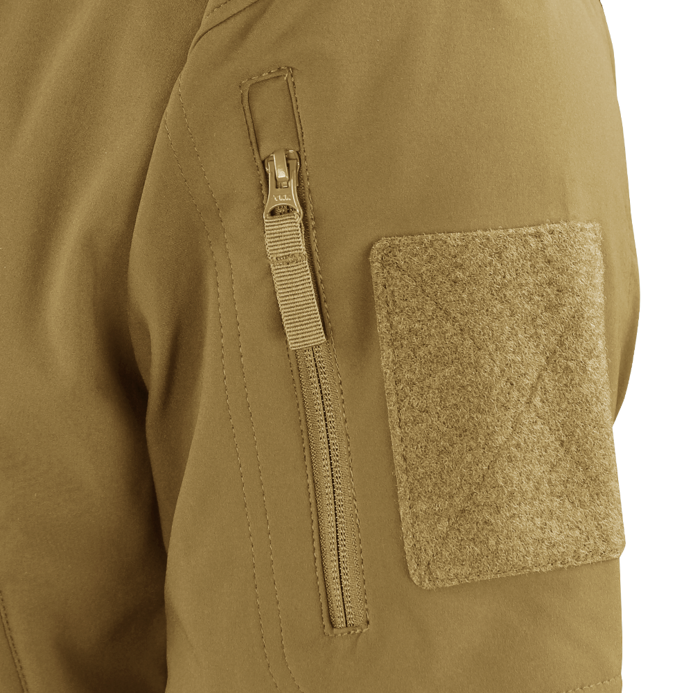 Close-up of the Condor Westpac Softshell Jackets tan sleeve, highlighting a vertical zipper pocket and a large rectangular hook-and-loop patch.