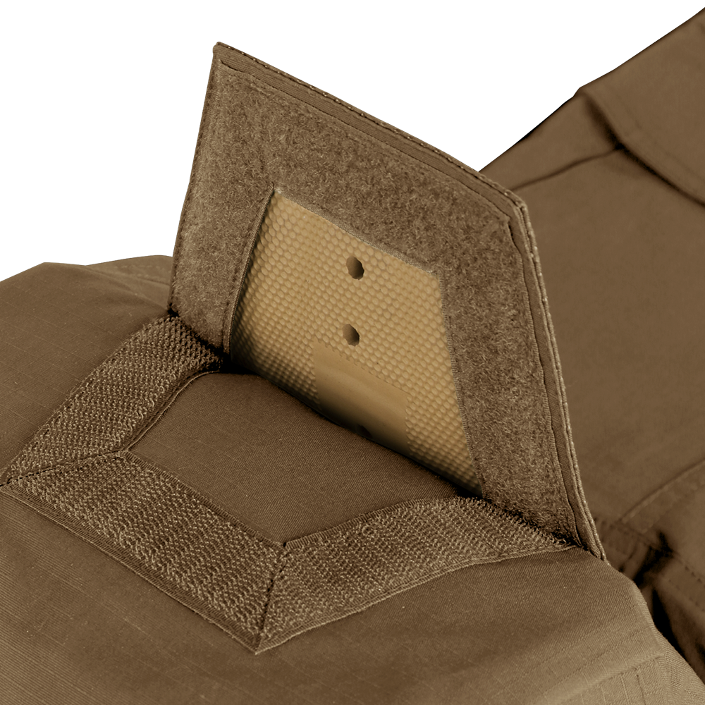 Close-up view of Condor Paladin Tactical Pants in tan, featuring a ballistic plate partially inserted into a pocket with hook-and-loop fasteners.