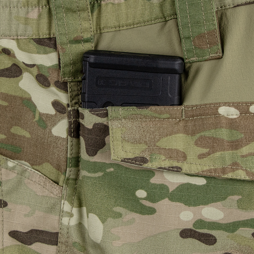 A black rifle magazine is partially visible in the front pocket of Condor Paladin Tactical Pants in MultiCam.