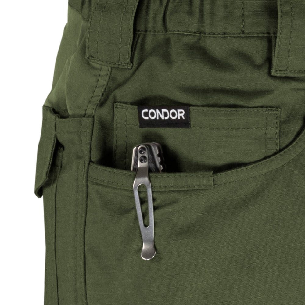 A tactical multitool with a metal pocket clip is partially visible in the front pocket of green Condor Odyssey Pants Gen III.