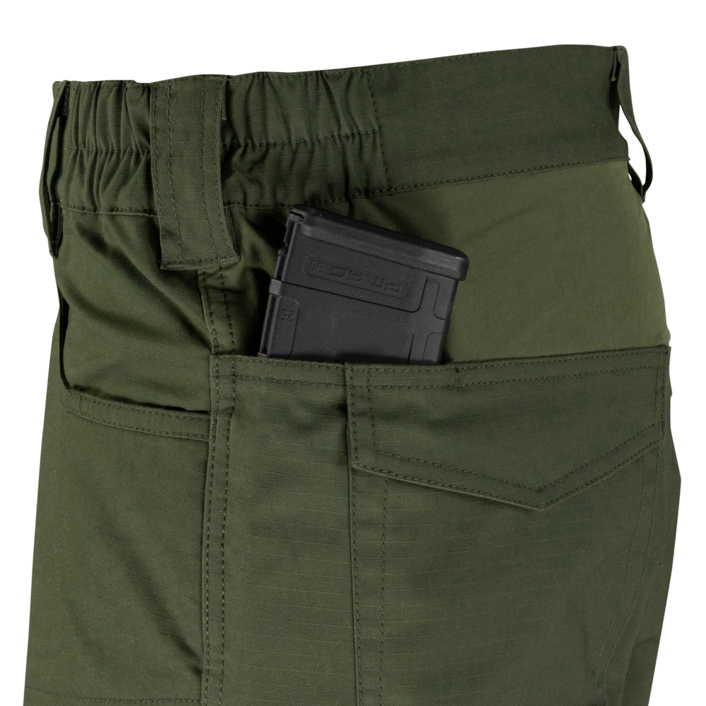 A close-up of Condor Odyssey Pants Gen III in olive green, featuring a black rifle magazine partially visible in the side pocket.