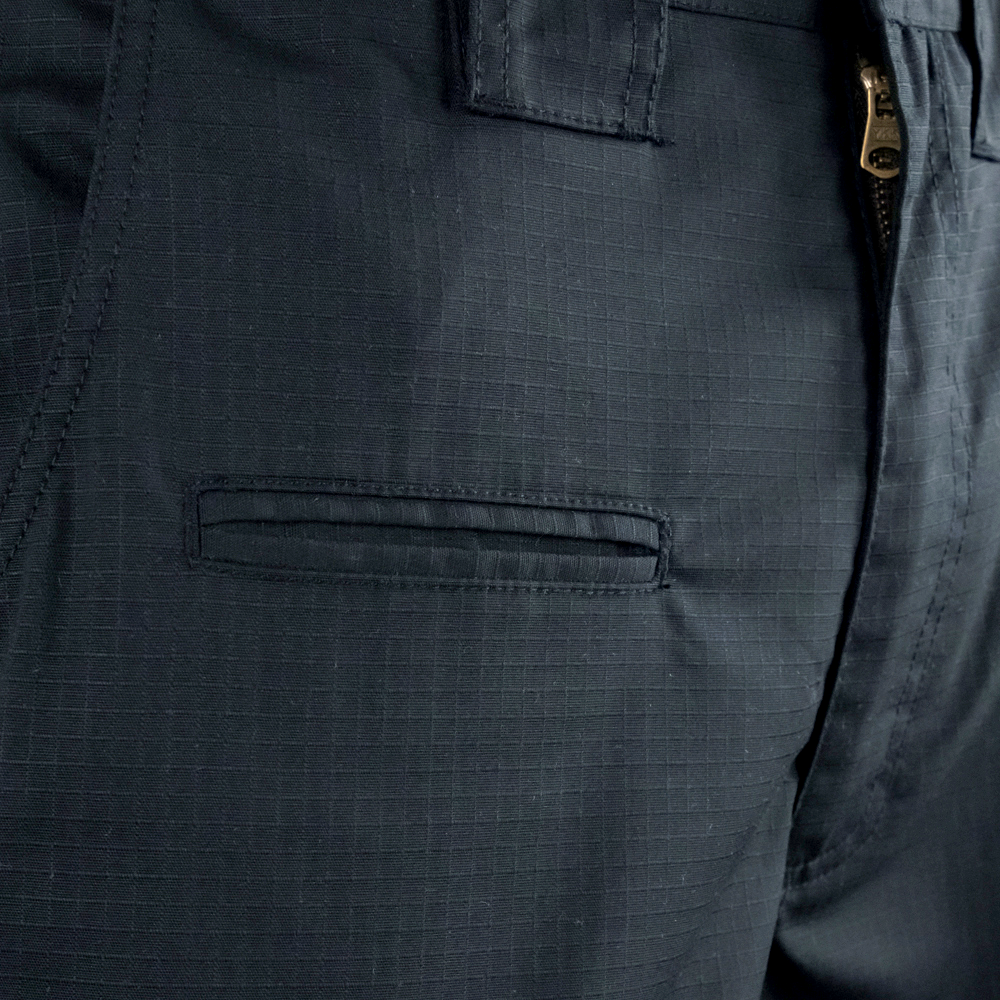 Close-up of Condor Mens Protector EMS Pants, highlighting the zipper, waistband, belt loop, and a horizontal pocket with a grid-patterned fabric.