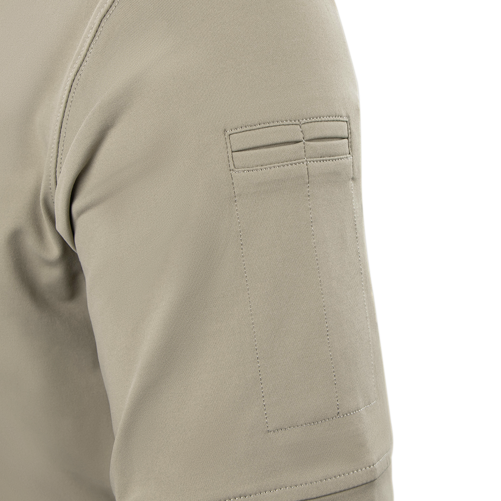 Close-up of a Condor Short Sleeve Dri-Flex Tactical Polo in beige, showing its sleeve with a rectangular patch pocket detailed by two stitched horizontal lines near the top.