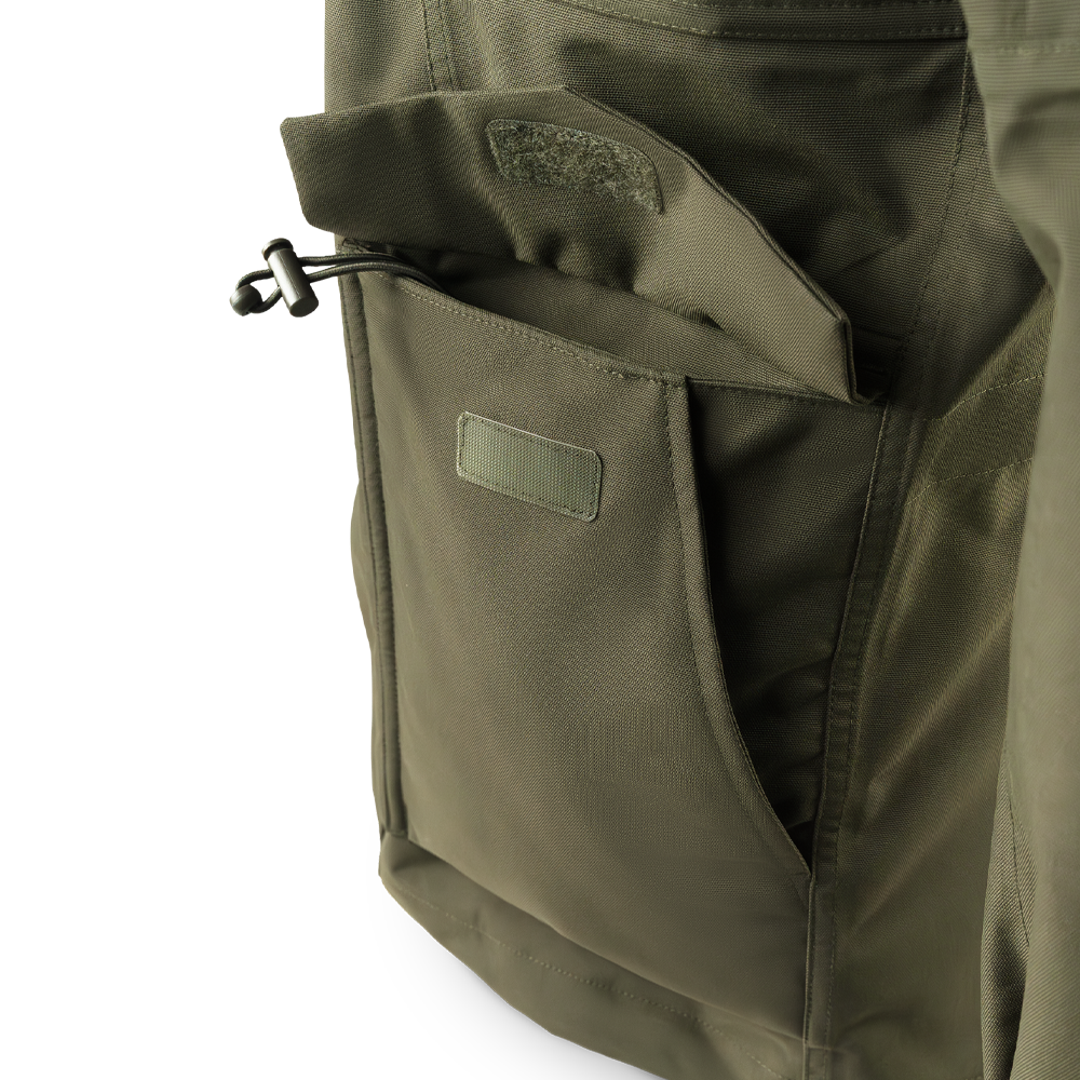 Close-up of the Condor Aegis Waterproof Parka’s olive green pocket featuring a flap closure and drawstring toggle.