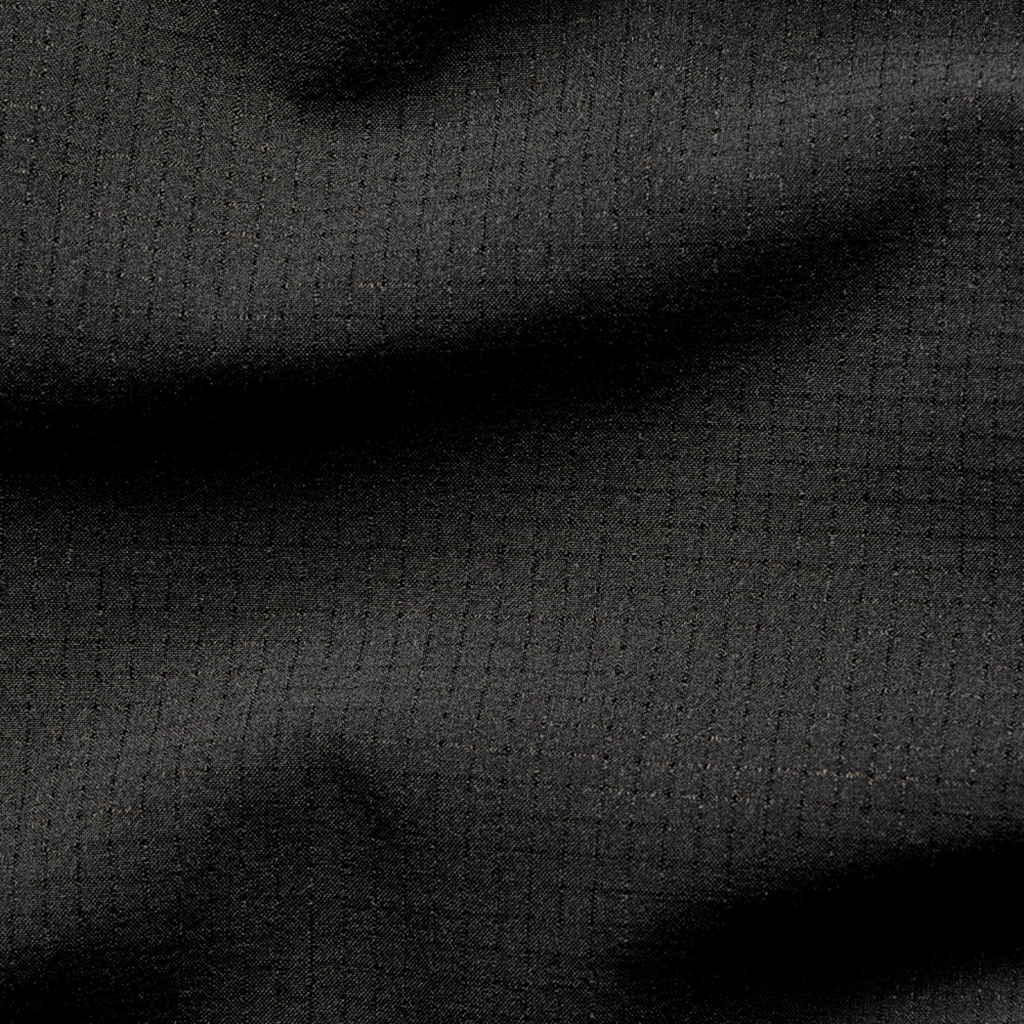 Close-up of the Condor Trident Sun Shirt's black fabric, featuring a subtle grid pattern and slight wrinkles.