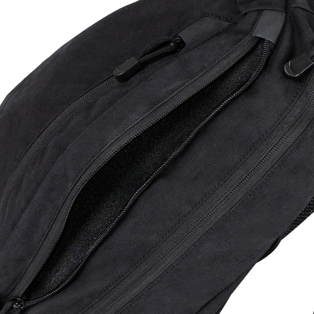 Close-up of a partially unzipped Condor Elite Sector Sling Bag 18L by Condor, highlighting the zipper and pull tabs.