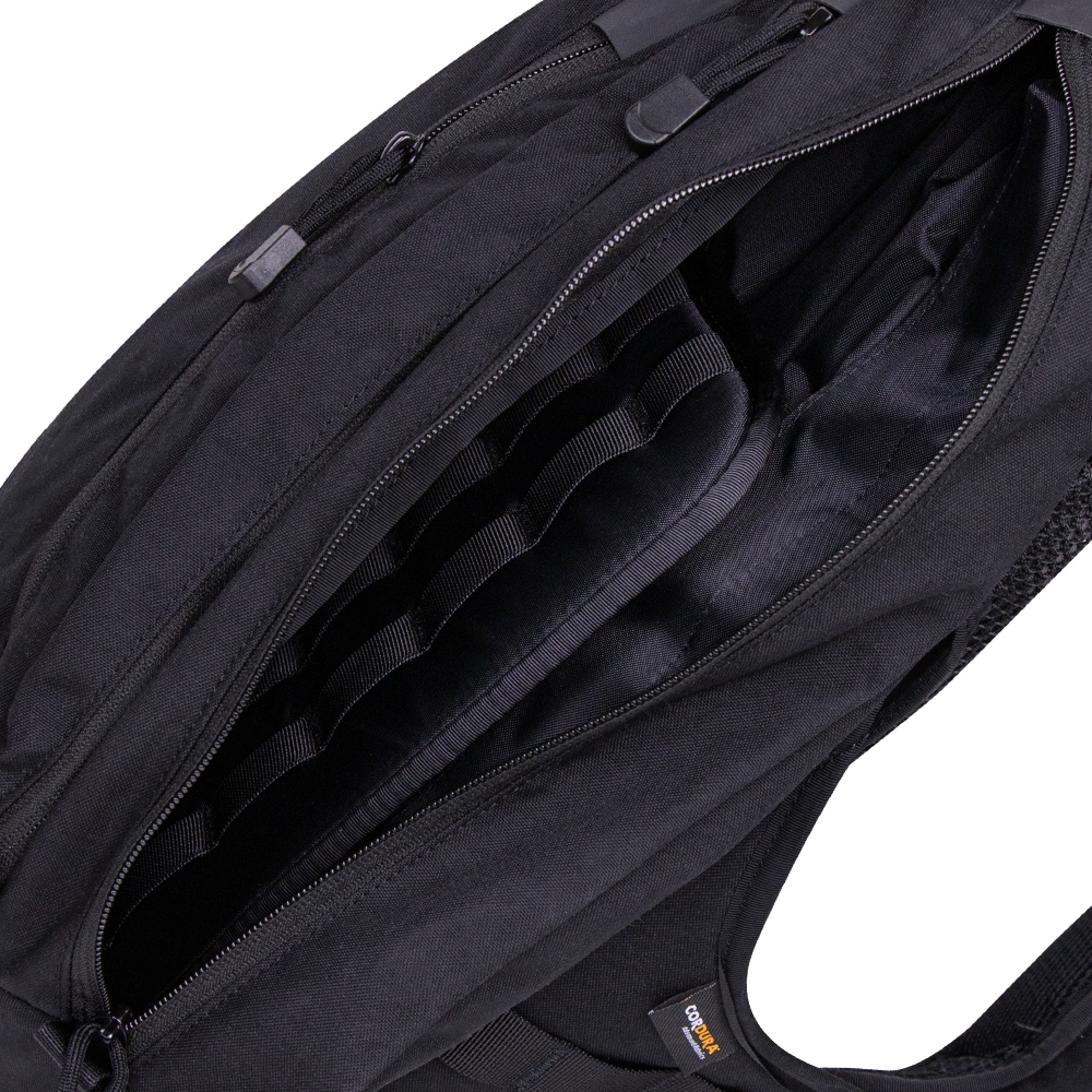A close-up view of the open Condor Elite Sector Sling Bag 18L by Condor, highlighting its interior compartments and zipper details.