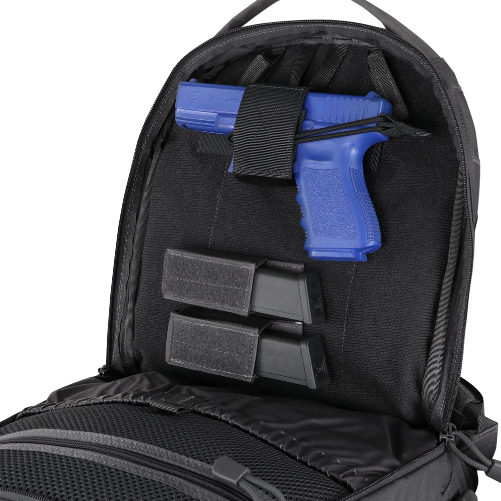 A blue training pistol and two black magazines are secured inside the back compartment of a Condor Elite Fail Safe Urban Backpack Gen II 18L by Condor.