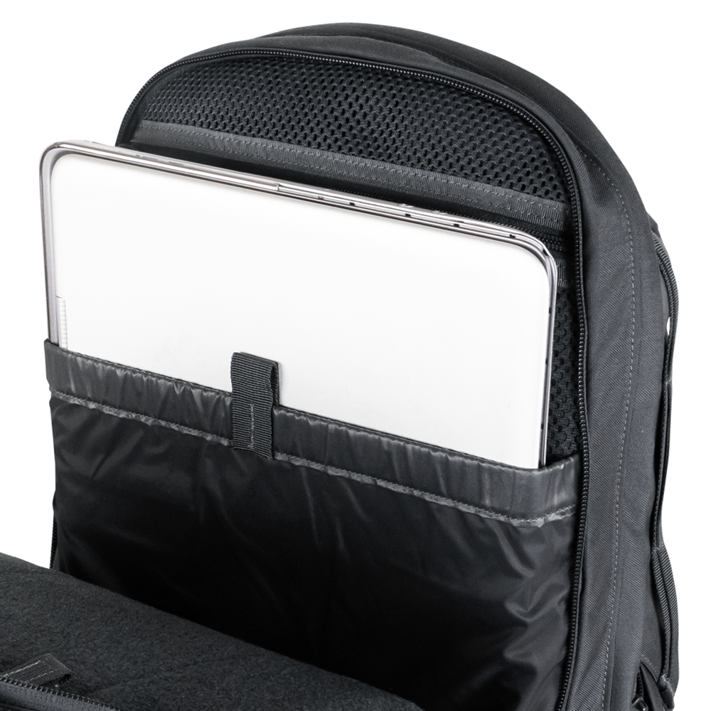 A silver laptop partially inserted into a padded compartment inside a Condor Elite Fail Safe Urban Backpack Gen II 18L by Condor, designed for first responder essentials.