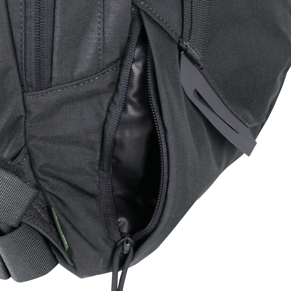 Close-up of the Condor Elite Fail Safe Urban Backpack Gen II 18L by Condor, featuring a black finish, partially open zippered pocket revealing fabric lining inside, and a plastic buckle on the strap.