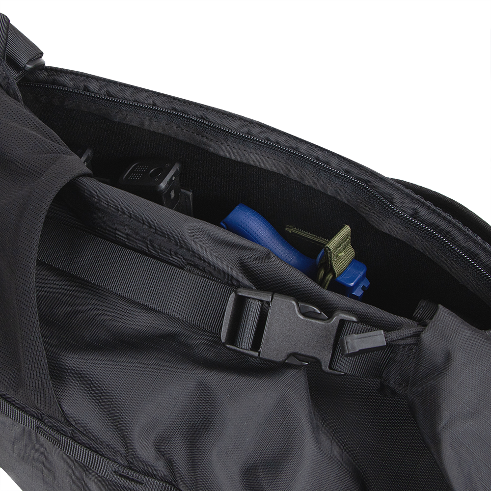 A close-up of the Condor Aero Roll-Top Backpack 25L reveals its interior, featuring a strap, buckle, and a partially visible blue object inside.