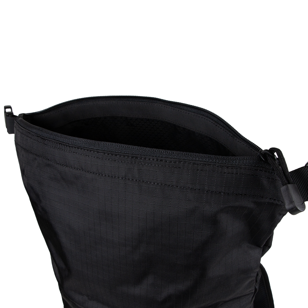 A close-up of the Condor Aero Roll-Top Backpack 25L shows its open black design, textured fabric, zippered closure, and visible shoulder strap.