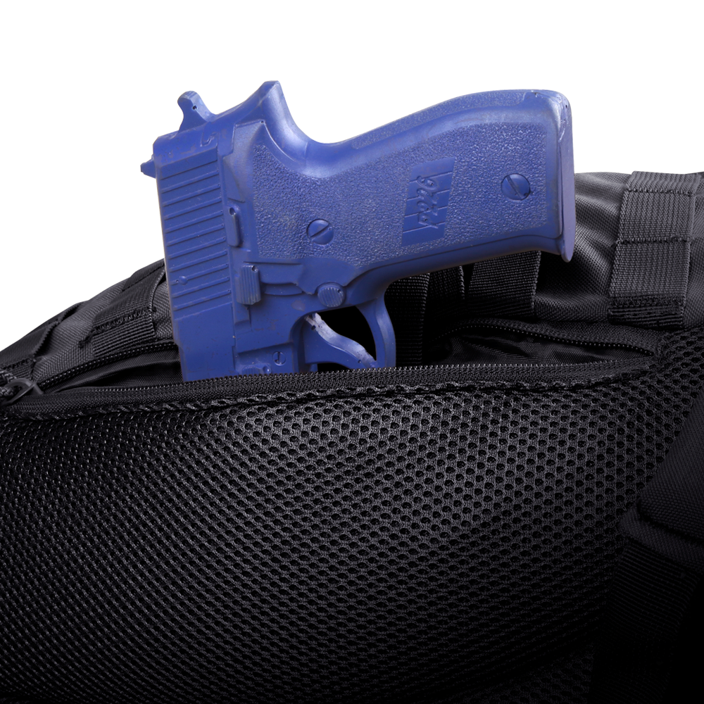 A blue training handgun is partially tucked into the zippered pocket of the Condor Ambidextrous Sling 27L, a black tactical bag made with mesh material.