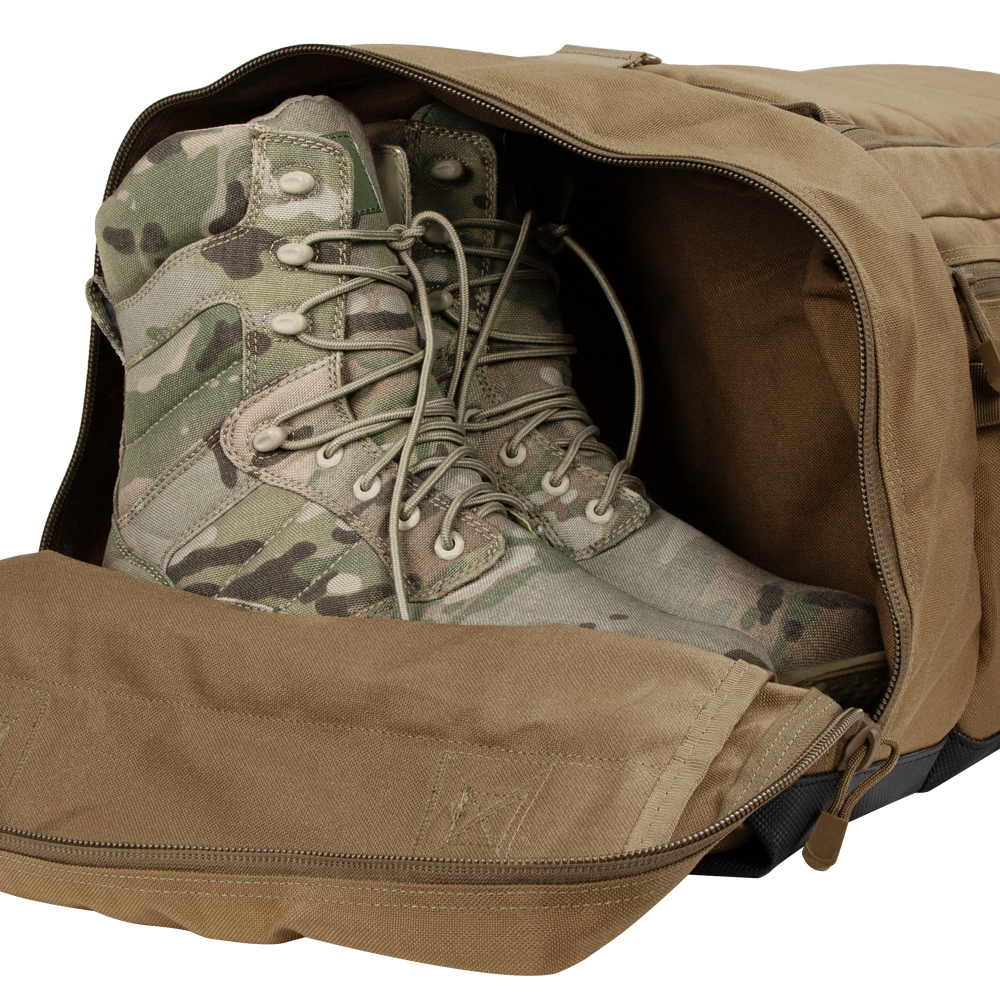 A pair of tactical camouflage military boots placed inside an open Condor Colossus Duffle Bag 60L.