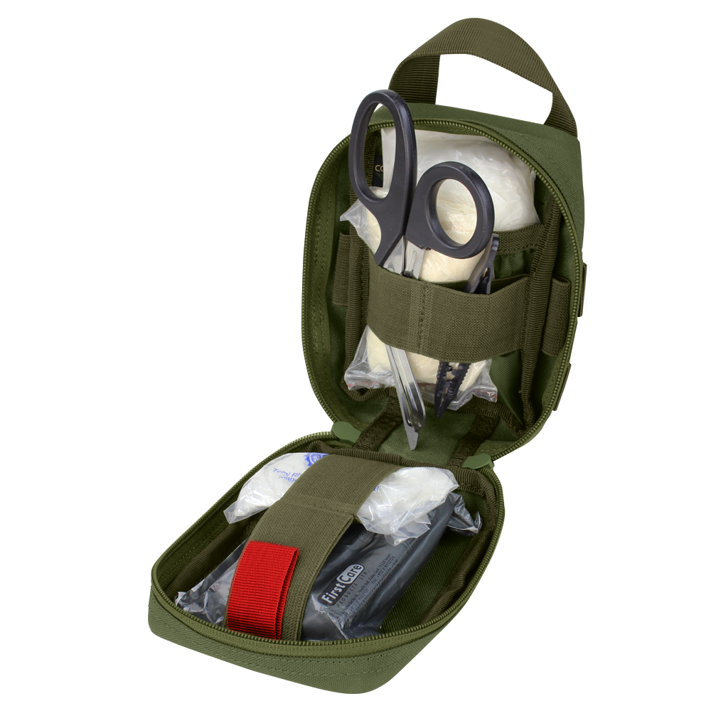 The Condor EMT Leg Rig is open, revealing medical scissors, gauze, bandages, and other emergency supplies neatly organized inside.