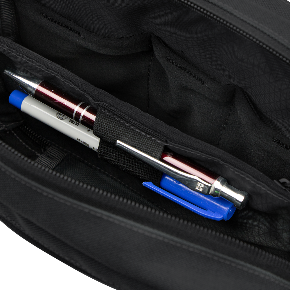 Close-up of the interior of the Condor Tech Pouch - MultiCam Black, showing two pens and a blue pen cap organized in dedicated pen slots.