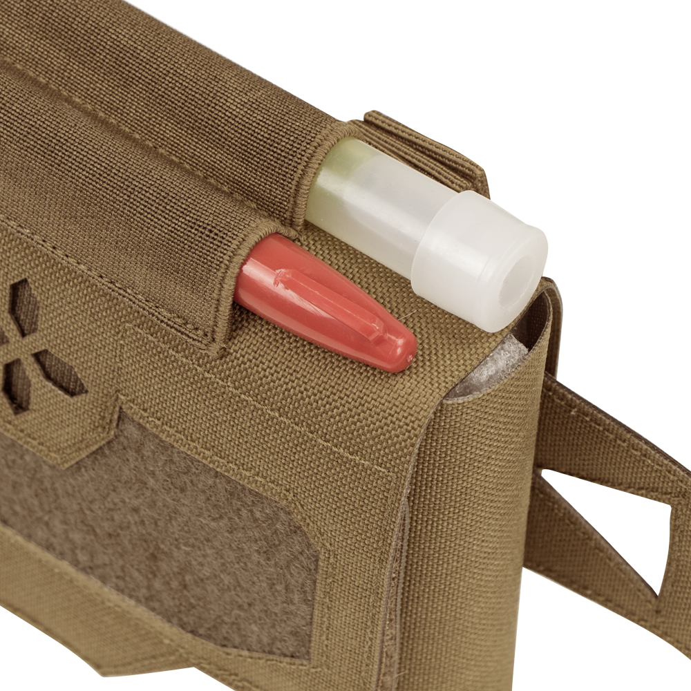 A close-up of the Condor Micro TK Pouch Gen II in tan, showing a red pen and white-capped tube inside, plus hook-and-loop patch and strap—perfect for organizing first responder essentials.