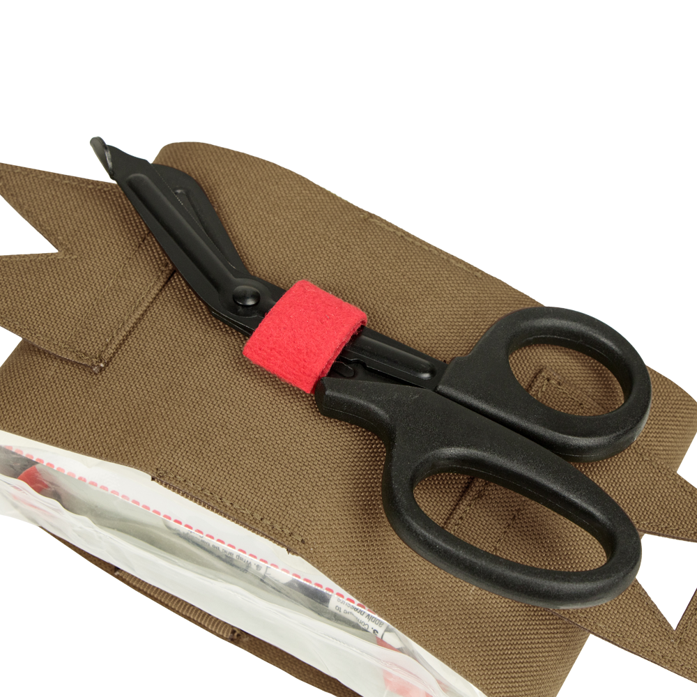 A pair of black trauma shears with a red band, favored by first responders, rests on a Condor Micro TK Pouch Gen II with a partially open zippered compartment.