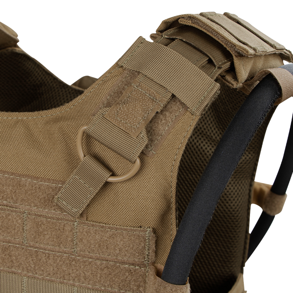 Close-up of the Condor Gunner Plate Carriers tan shoulder strap, featuring MOLLE webbing, D-ring, hook-and-loop fasteners, and hydration tube—perfect for bushcraft or law enforcement EDC.