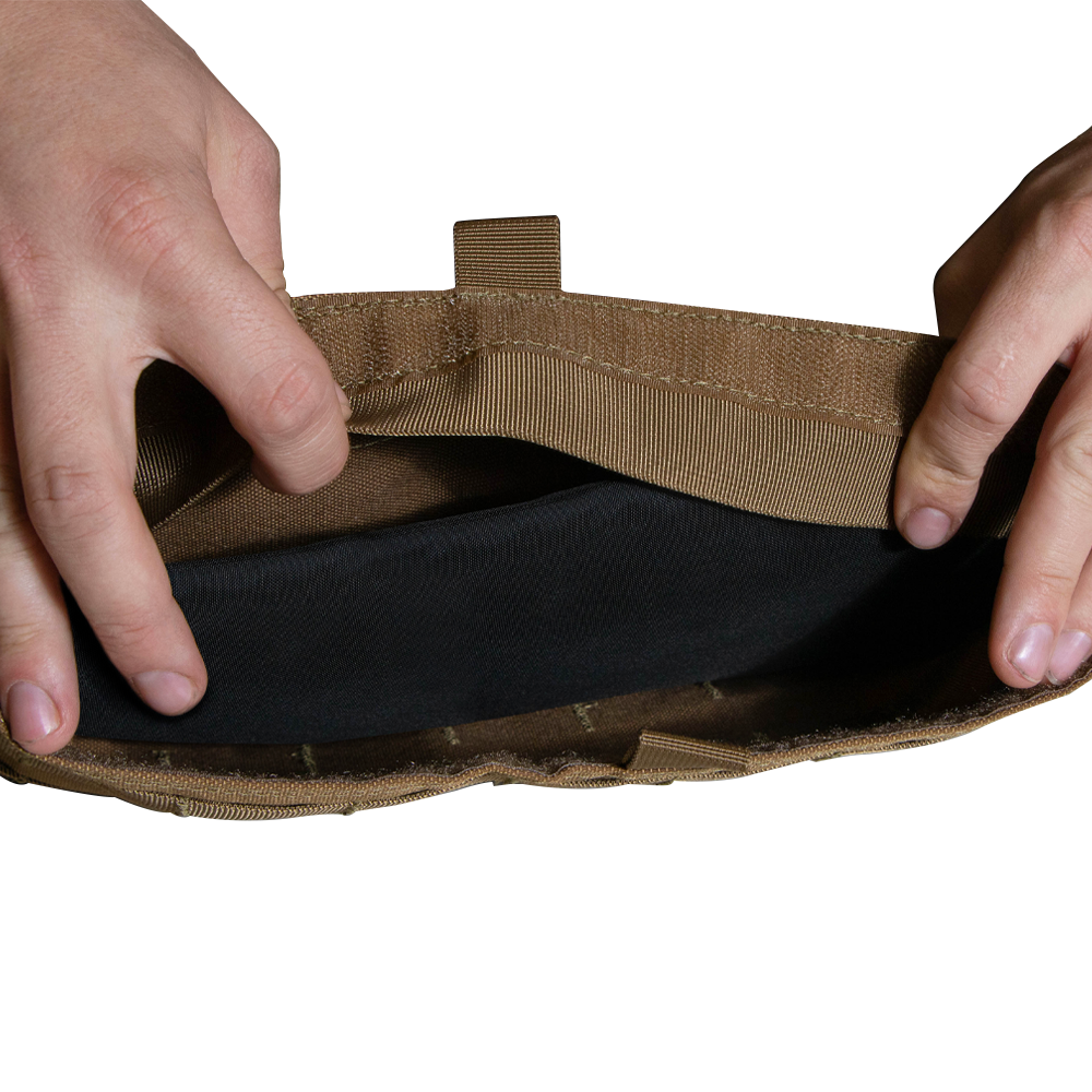 Two hands open the pocket of a Condor Enforcer Releasable Plate Carrier, revealing a black insert inside—perfect for those who need organized tactical gear storage.