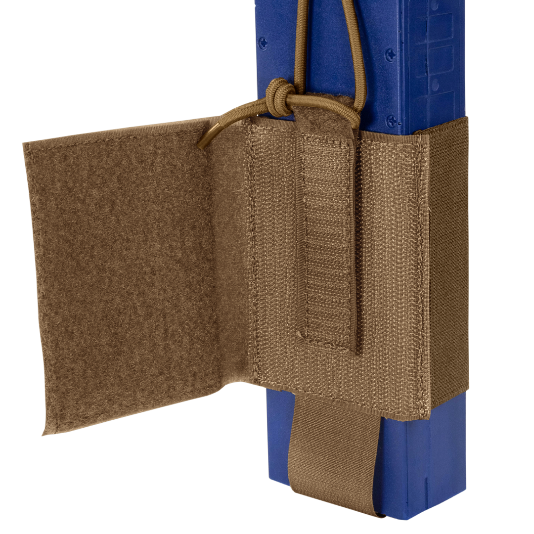A close-up of the Condor VAS Wing Pouch in tan, designed for EDC or bushcraft, securely holds a blue rectangular object with adjustable straps and a hook-and-loop flap.