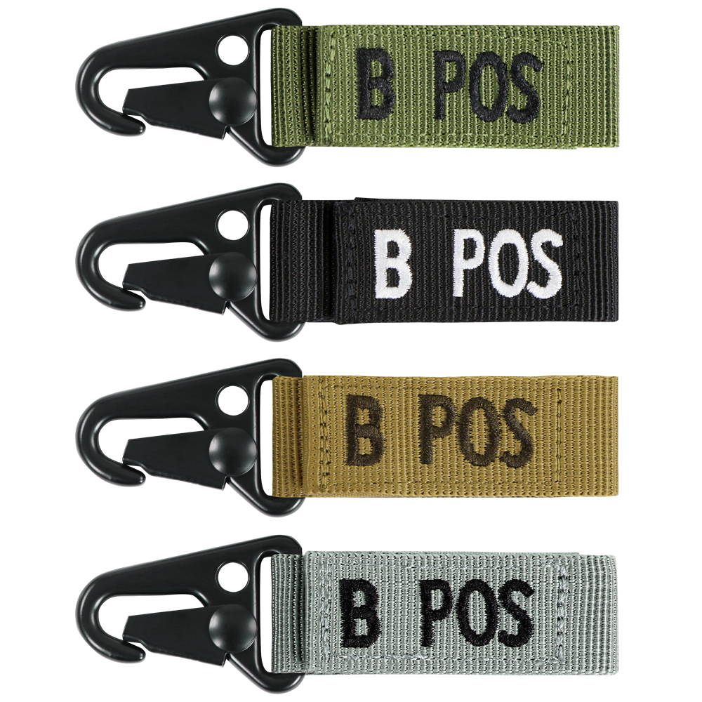 The Condor Blood Type Key Chain set features four keychains with plastic clips and fabric tags labeled B POS, available in green, black, tan, and gray.