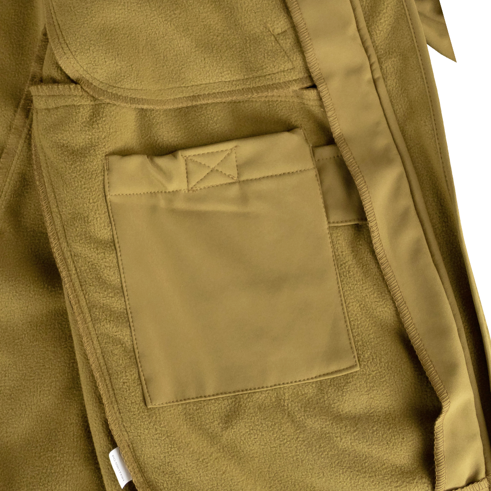 Close-up of the Condor Phantom Softshell Jacket in tan, showing a rectangular fabric pocket with visible stitching and a belt loop on the right side.