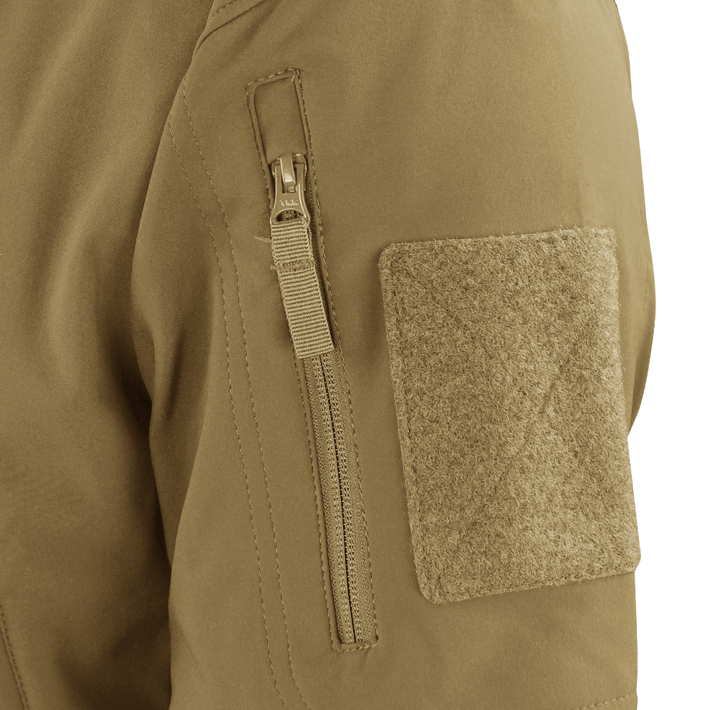Close-up of the Condor Summit Zero Softshell Jacket’s tan sleeve, highlighting a vertical zipper pocket and a rectangular hook-and-loop patch.