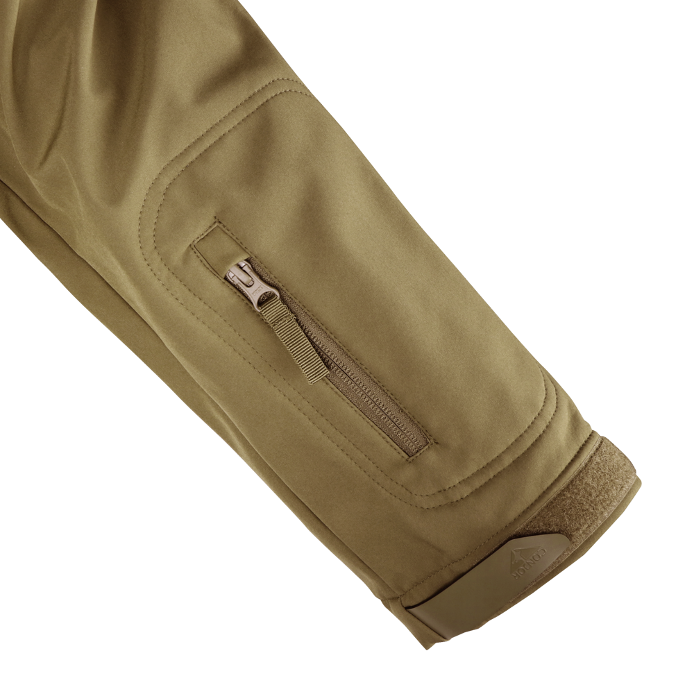 A close-up of the Condor Summit Zero Softshell Jacket in khaki shows its sleeve with a zippered pocket and hook-and-loop fastener at the cuff.