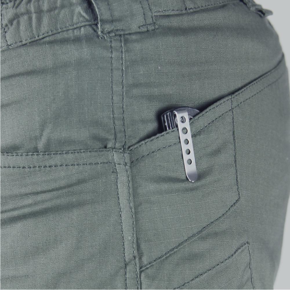 A metal pocket clip of a folding knife, part of an EDC setup, is visible clipped to the side pocket of Condor Stealth Operator Pants.