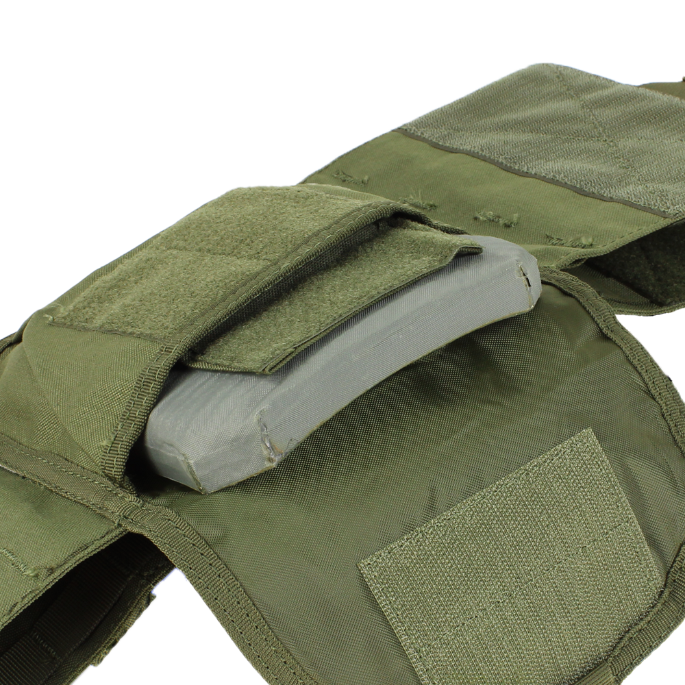 A close-up of the Condor Defender Plate Carrier in green, featuring an open pocket that reveals a ballistic plate inside.