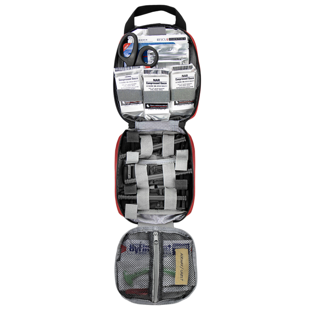 The Condor Rip-Away EMT Pouch opens to reveal scissors, bandages, gauze packs, medical tape, and various supplies neatly organized in mesh and elastic compartments.