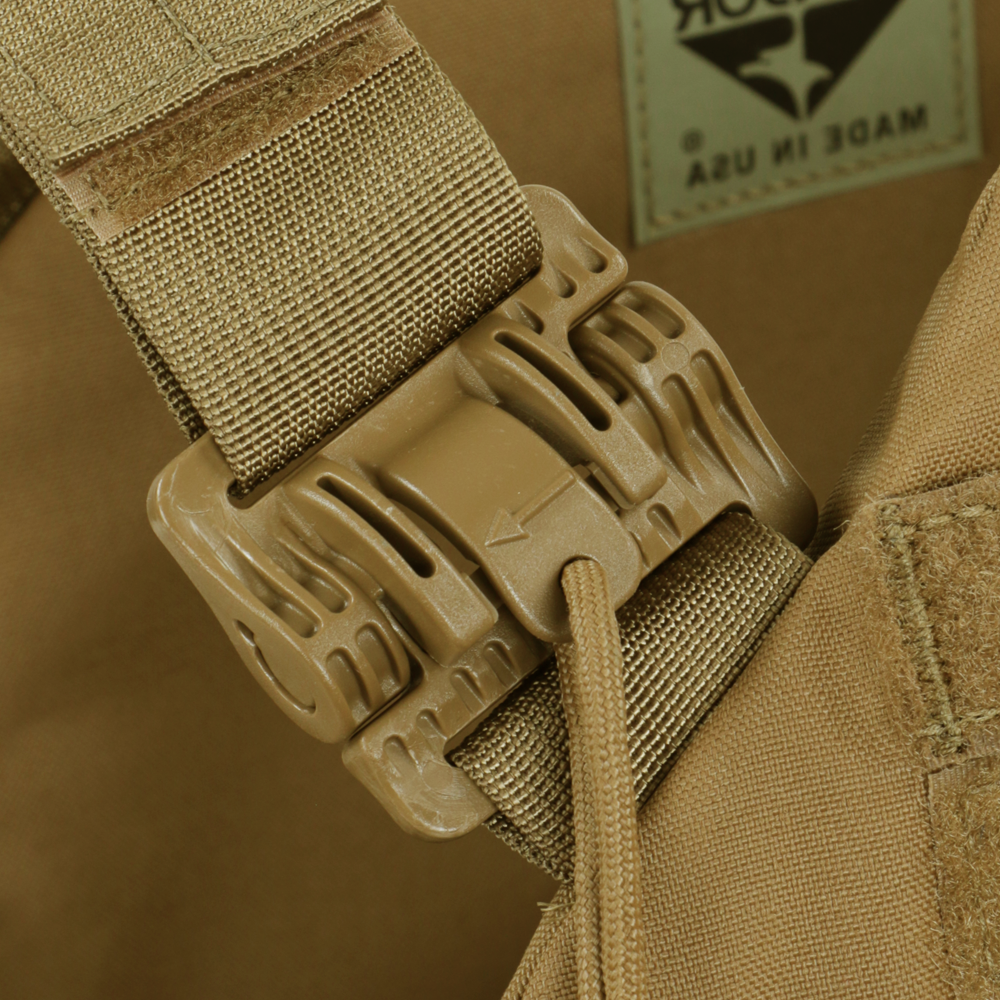 Close-up of a tan plastic buckle and strap on a Condor Cyclone RS Plate Carrier in MultiCam, with part of the Made in USA label visible in the background.